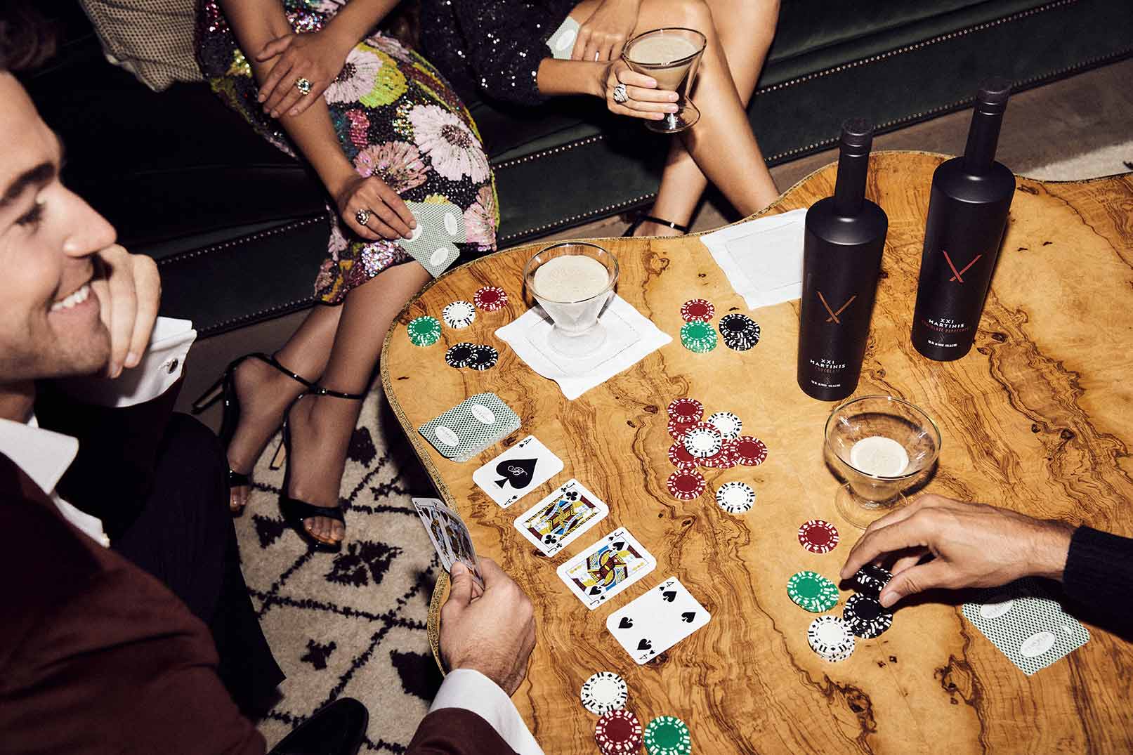 Group playing cards and drinking XXI Martinis